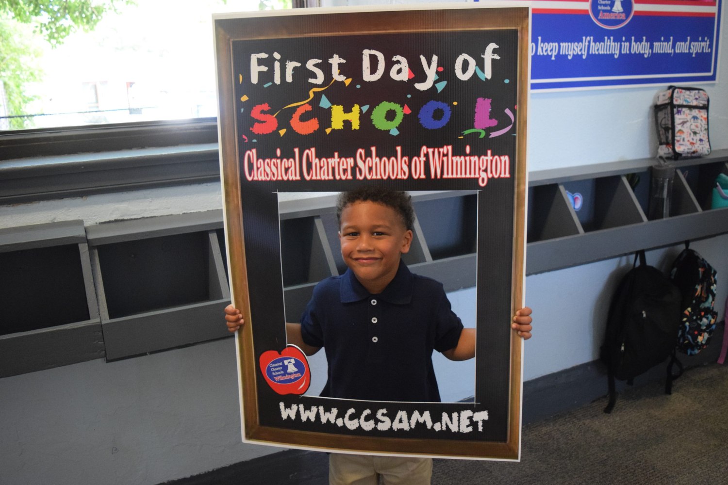 A student poses inside a first-day-of-school photo frame at CCS Wilmington.