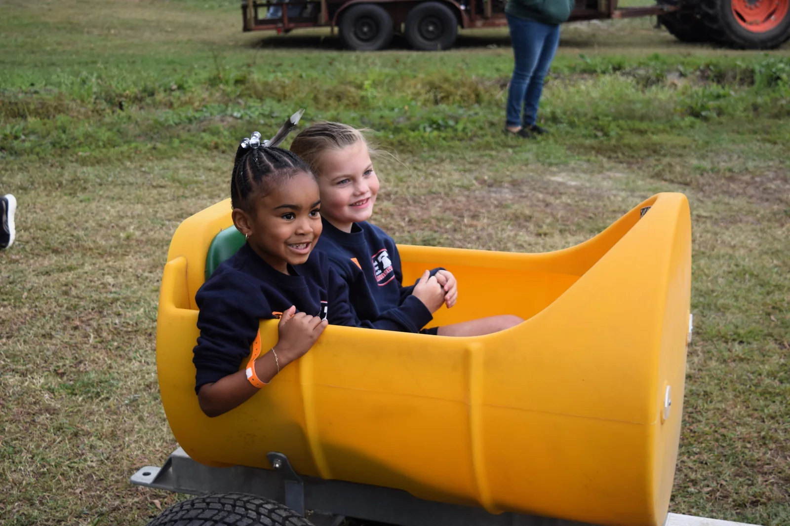Two students smile during an outdoor school activity.